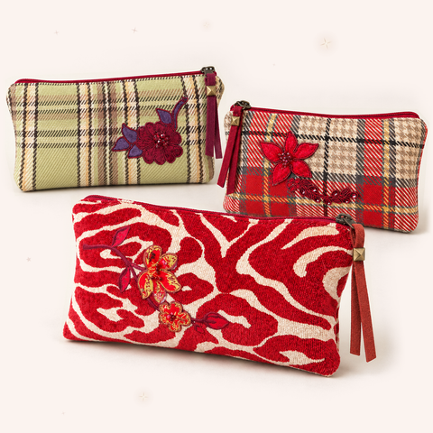 Atenti Holiday Bloom Trio of three plaid and scarlet zebra pouches on blush ivory with subtle rose-gold and champagne stars.
