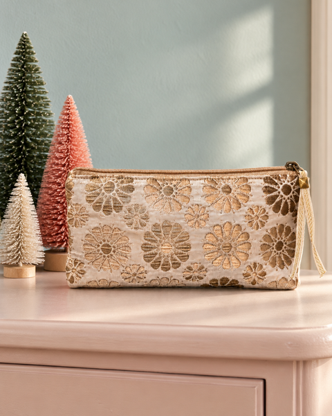 Atenti Jelly Bean Tall Tool Pouch in cream and gold woven floral fabric beside miniature holiday trees.