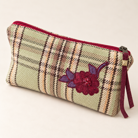 Angled view of Atenti Mistletoe Plaid Tall Tool Pouch, showing burgundy floral applique and a matching zipper pull.