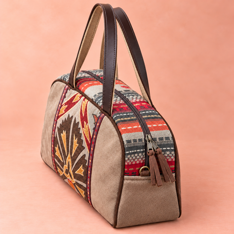 Tapestry Overnighter elevated view of striped woven top, zipper and long handles