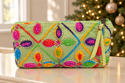 Atenti Confetti Garden Tall Tool Pouch with bright floral embellishment beside a softly lit Christmas tree.