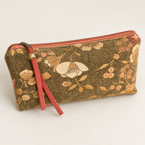 Angled view of Atenti Woodland Bloom Tall Tool Pouch, showing its textured floral fabric and coral zipper pull.